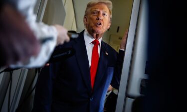 President Donald Trump speaks to reporters on Air Force One on October 31