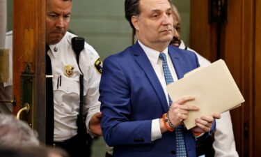 Brian Walshe enter the courtroom clutching papers and a rosary on Monday as his murder trial got underway in Norfolk Superior Court in Dedham