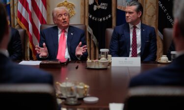 President Donald Trump speaks as Secretary of Defense Pete Hegseth looks on during a meeting in the Cabinet Room of the White House on Tuesday.