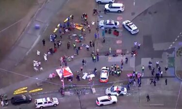 A police officer walks along cordon tapeline at the scene of a mass shooting at Bondi Beach on December 14