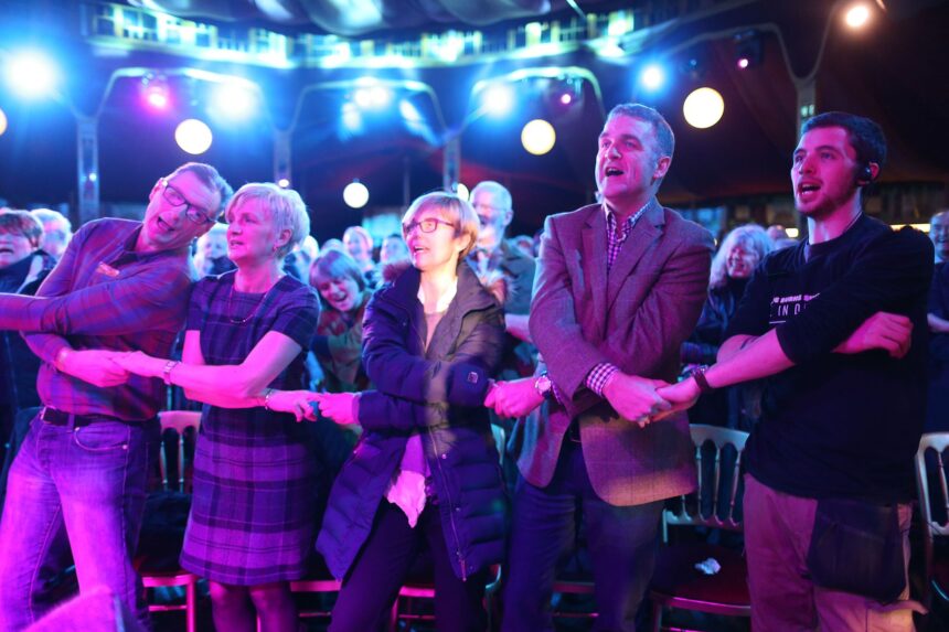 Revellers sing link arms while singing "Auld Lang Syne."