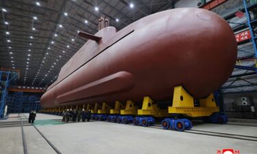 North Korea's leader Kim Jong Un is briefed on the construction of the country's first nuclear-powered submarine.
