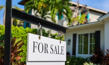 A worker hangs drywall for a new home under construction at a development in Yukon