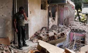 Wilman Gonzalez stands at his home
