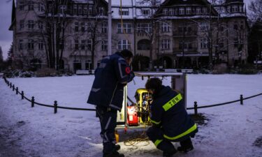 Some battery-operated Christmas decorations are seen in windows of a residential building in the Zehlendorf district on Sunday morning amid a power blackout.