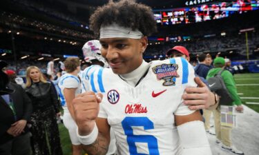 Chambliss celebrates with the trophy after Ferris State won the Division II national championship in 2024.