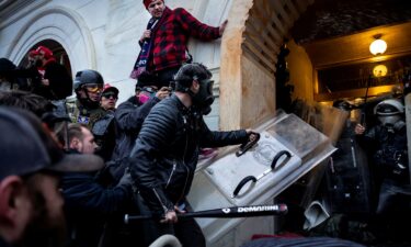 Supporters of Donald Trump clash with police and security forces as they storm the US Capitol on January 6