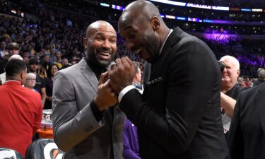Derek Fisher and Kobe Bryant share a moment at halftime after both of Bryant's #8 and #24 Los Angeles Lakers jerseys are retired at Staples Center on December 18