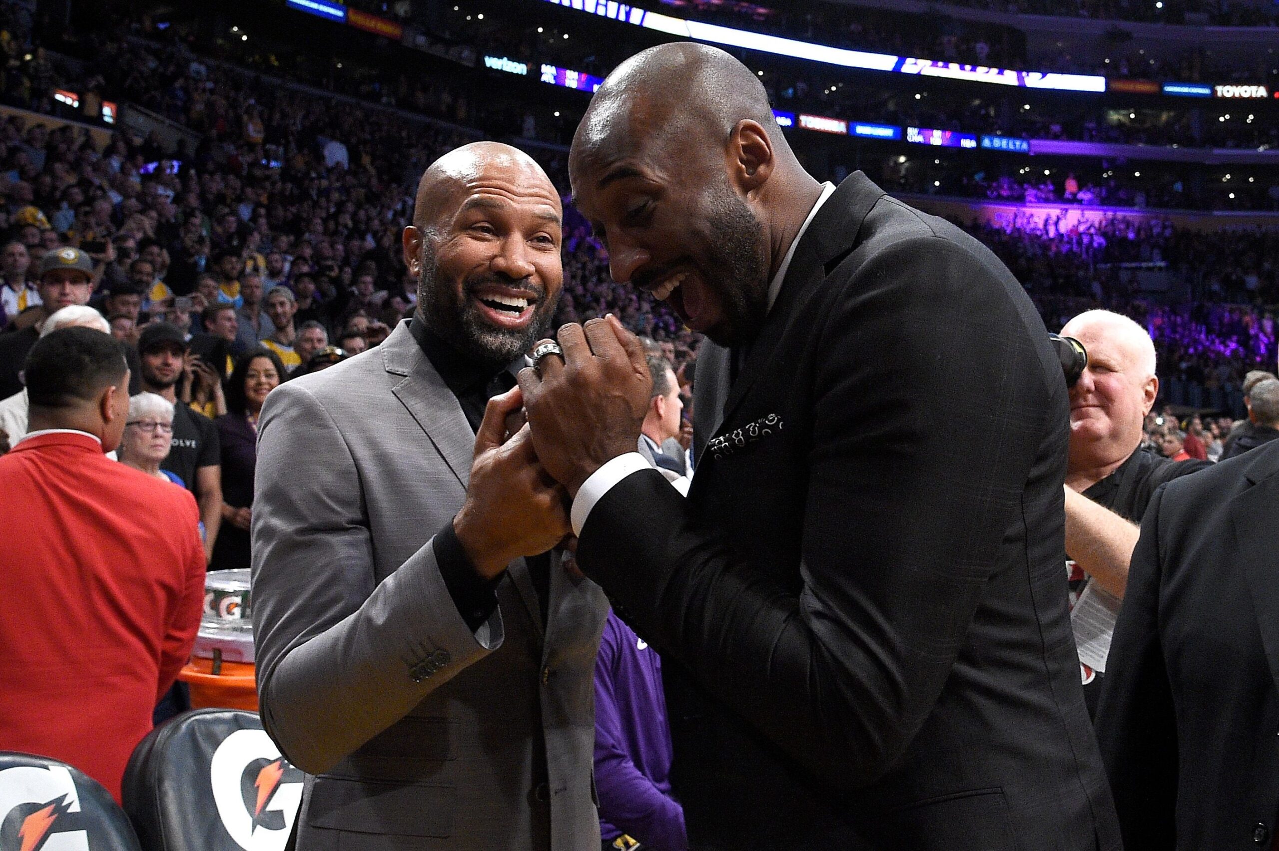 <i>Kevork Djansezian/Getty Images via CNN Newsource</i><br/>Derek Fisher and Kobe Bryant share a moment at halftime after both of Bryant's #8 and #24 Los Angeles Lakers jerseys are retired at Staples Center on December 18