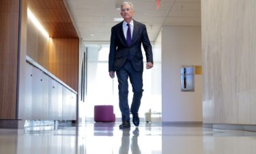 Federal Reserve Chair Jerome Powell walks between meetings at the Fed on January 13