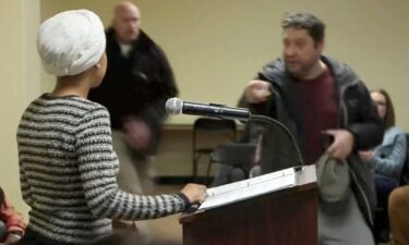 A man shouts at Rep. Ilhan Omar after spraying an unknown substance toward her