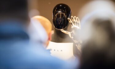 An attendee plays table tennis with a Sharpa robot during the annual Consumer Electronics Show in Las Vegas