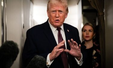 President Donald Trump speaks to reporters on Air Force One en route to Joint Base Andrews