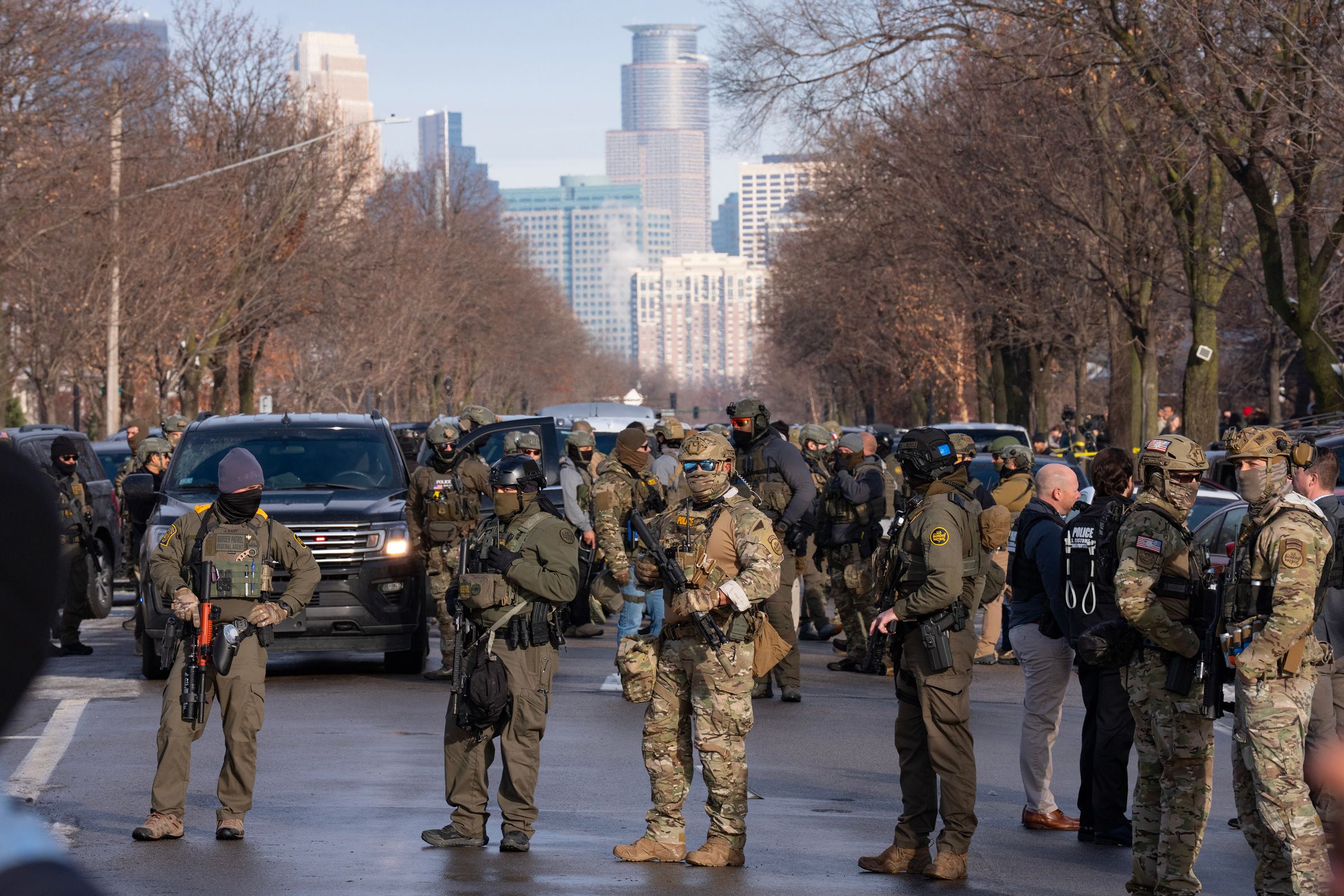 <i>Alex Kormann/The Minnesota Star Tribune/Getty Images via CNN Newsource</i><br/>Federal agents including ICE and US Border Patrol stand with weapons along Portland Ave. near the scene where federal agents shot and killed a woman earlier in Minneapolis