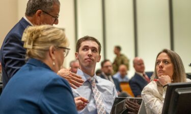 Tyler Robinson speaks with his attorneys before a hearing in Provo