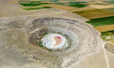 A girl with canisters of water from a water truck