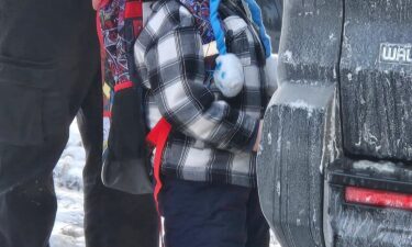 Federal immigration agents walk 5-year-old Liam Conejo Ramos to a vehicle in front of his Minneapolis home on Tuesday.