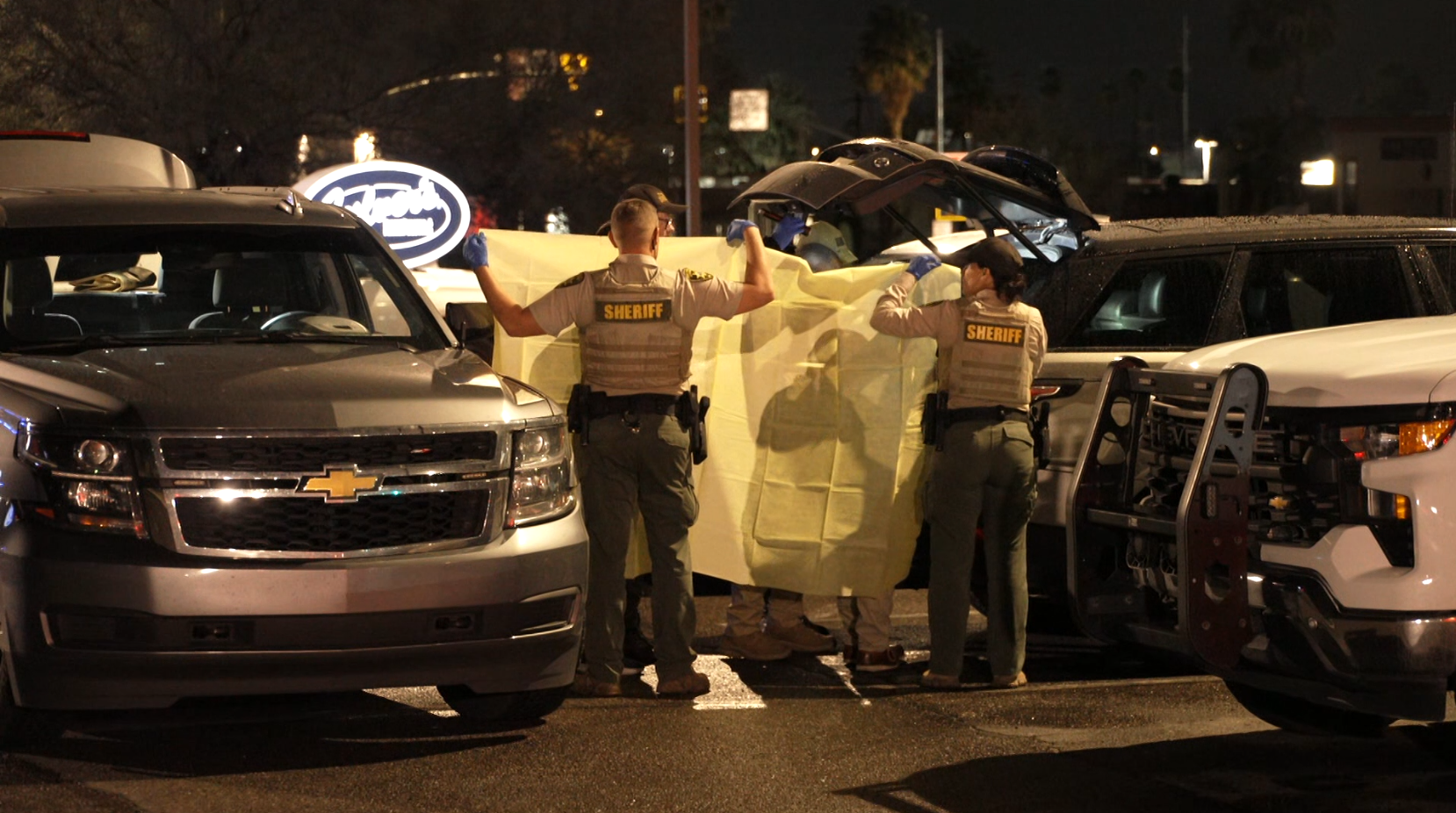 The FBI and Pima County Sheriff’s Department deputies process evidence from a late-model, gray Range Rover at a Culver’s in Tucson.