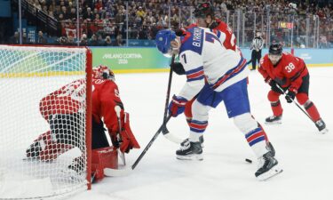 Jordan Binnington of Canada makes a save against Brady Tkachuk of the United States in the men's ice hockey gold medal game during the Milano Cortina 2026 Olympic Winter Games in Milan