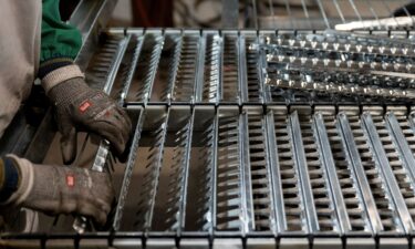 A worker handles components for a steel sieve at HCC