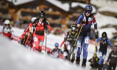 Athletes ski uphill after the start of a World Cup Team Relay event at Stelvio Alpine Skiing Centre in Bormio