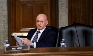Sen. Mark Kelly takes his seat during a Senate Armed Services Committee confirmation hearing on Capitol Hill