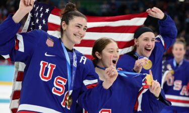 US players celebrate after winning the women's gold medal in the hockey final.