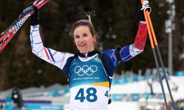 French biathlete Julia Simon celebrates after crossing the finish line to win gold on Wednesday.