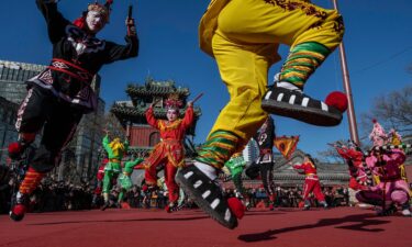 Chinese dancers dressed in traditional style clothing perform a Yingge dance during Lunar New Year celebrations at the Dongyue Taoist Temple in Beijing