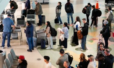 TSA agents assist travelers at Ronald Reagan Washington National Airport in Arlington