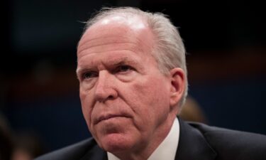 A Secret Service agent stands in front of framed images of President Donald Trump and former President Joe Biden's autopen signature