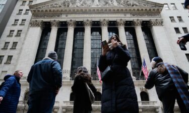 An attendant helps a motorist fill a car at the Sinopec petrol station in Beijing on March 9