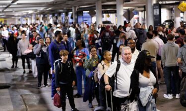 Travelers wait in line at a Transportation Security Administration checkpoint at William P. Hobby Airport in Houston