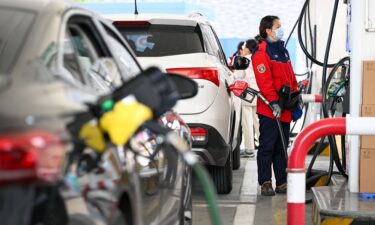 A worker refills a car at a gas station in Nanjing in eastern China on March 9