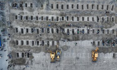 Rescue workers and residents search through the rubble in the aftermath of a strike on an elementary school in Minab