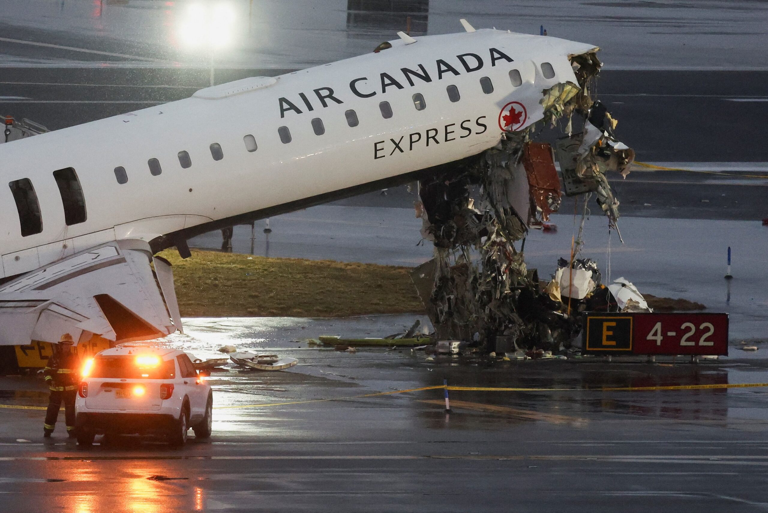 <i>Shannon Stapleton/Reuters via CNN Newsource</i><br/>Debris hangs from an Air Canada jet Monday at New York's LaGuardia Airport.