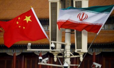 The national flags of China and Iran fly in Beijing's Tiananmen Square on February 14