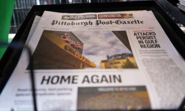 The printed edition of the Pittsburgh Post-Gazette sits in a newspaper rack