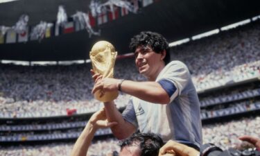 Fans of the late soccer star Diego Maradona stand outside court on the first day of the trial of his medical team for alleged homicide by negligence in San Isidro