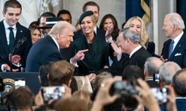 President Donald Trump gestures to Supreme Court Chief Justice John Roberts after being sworn in at his inauguration in the US Capitol Rotunda on January 20