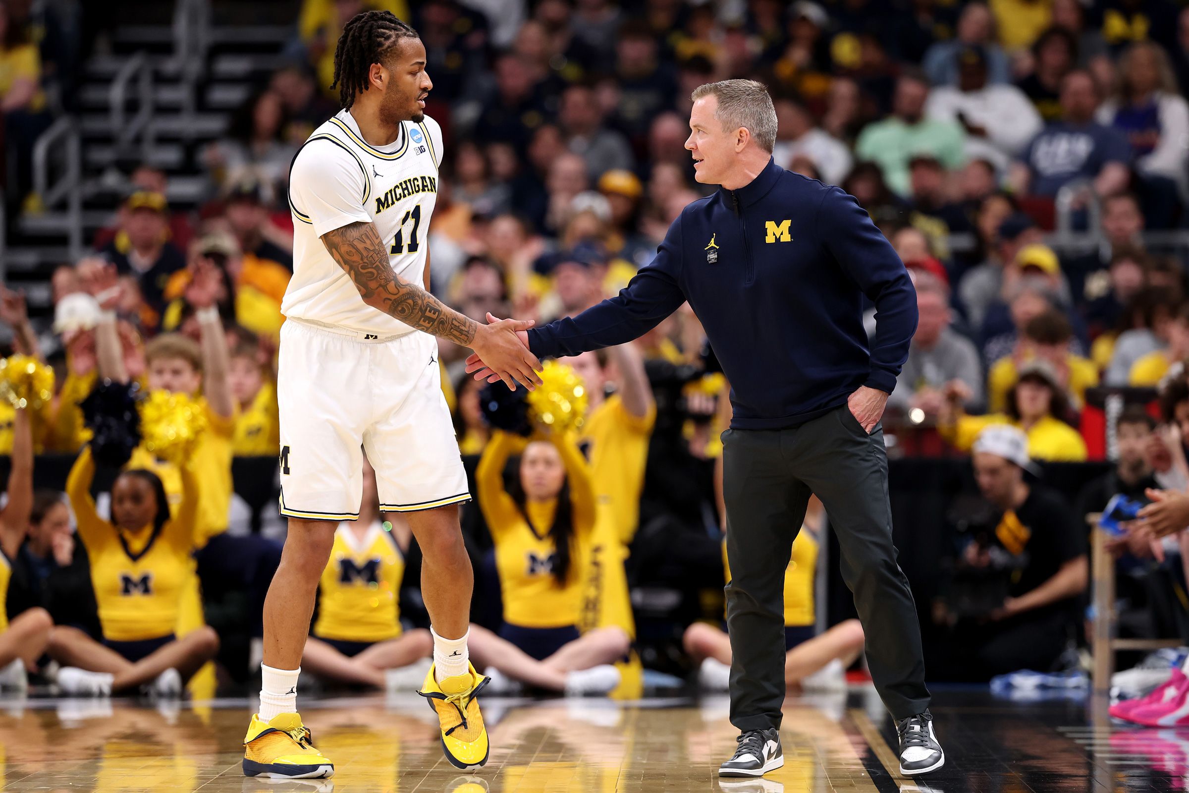 <i>Erin Hooley/AP via CNN Newsource</i><br/>Michigan head coach Dusty May celebrates with his team after defeating Tennessee in the Elite Eight.