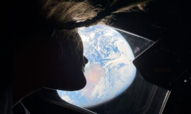 NASA astronaut Christina Koch looks back at Earth from one of the Orion spacecraft's windows.