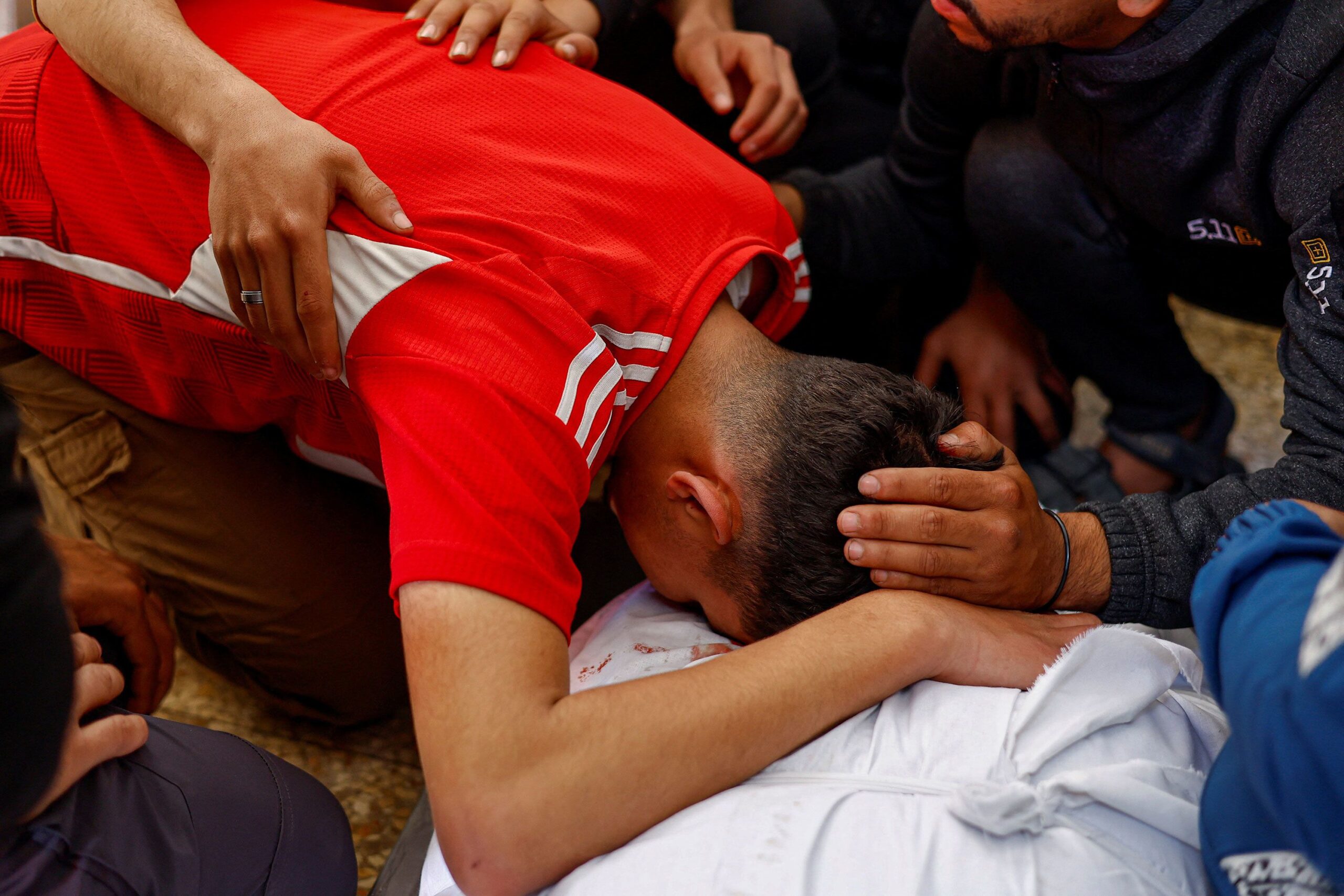 <i>Mahmoud Issa/Reuters via CNN Newsource</i><br/>A mourner leans over the body of Majdi Aslan at Al-Aqsa Martyrs Hospital in Deir al-Balah
