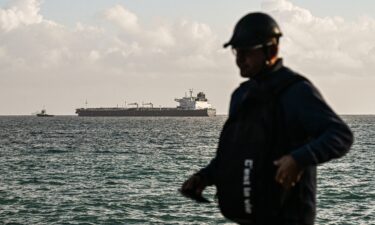 A tugboat guides a Russian oil tanker at a terminal in northwestern Cuba on March 31