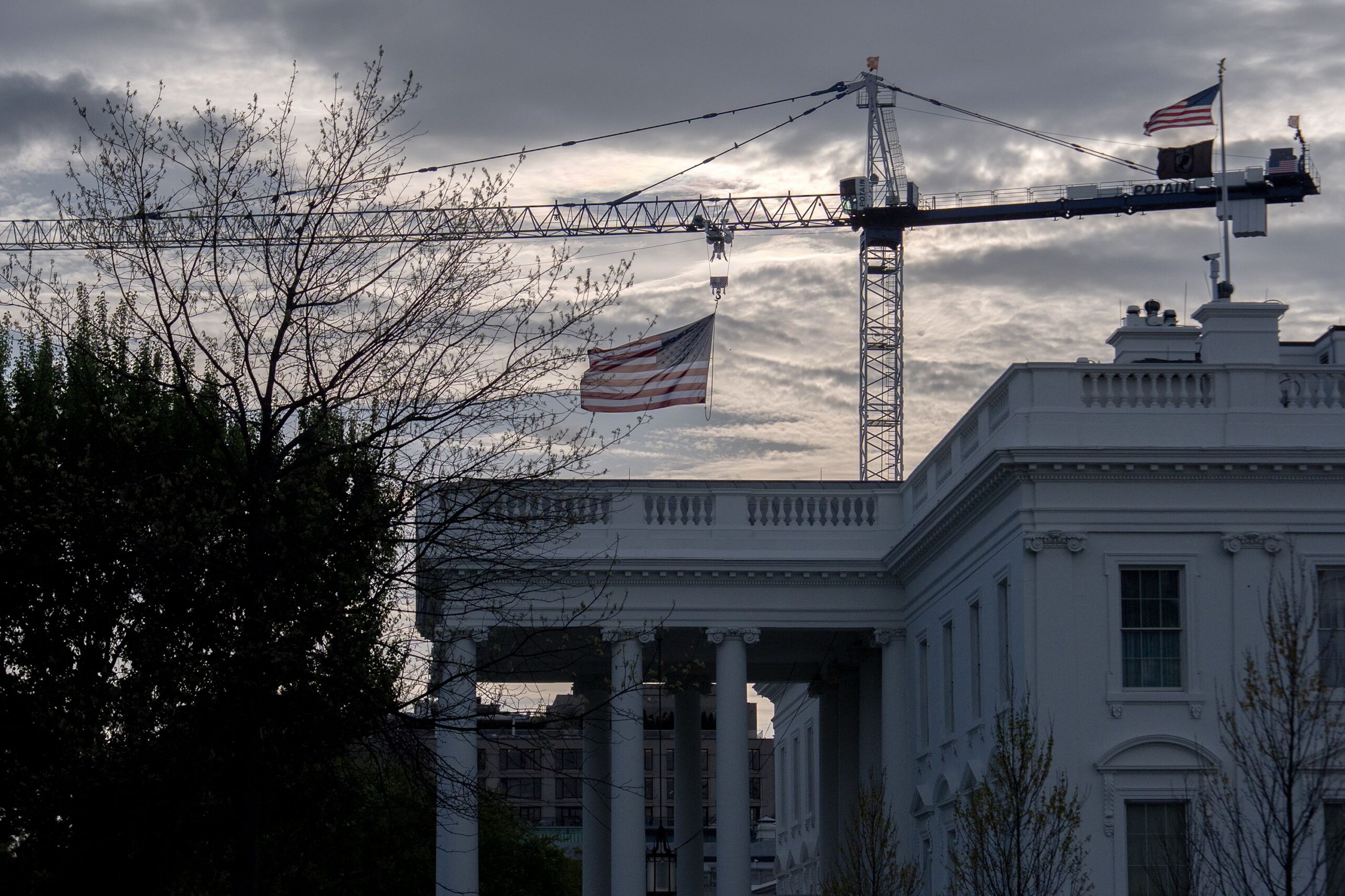 <i>Julia Demaree Nikhinson/AP via CNN Newsource</i><br/>A crane being used to construct the new White House ballroom is seen next to the White House