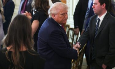 President Donald Trump shakes hands as he departs after making remarks during a NCAA Collegiate National Champions Day event