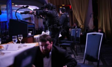 Agents stand guard after President Donald Trump was evacuated from the White House Correspondents' Association Dinner.