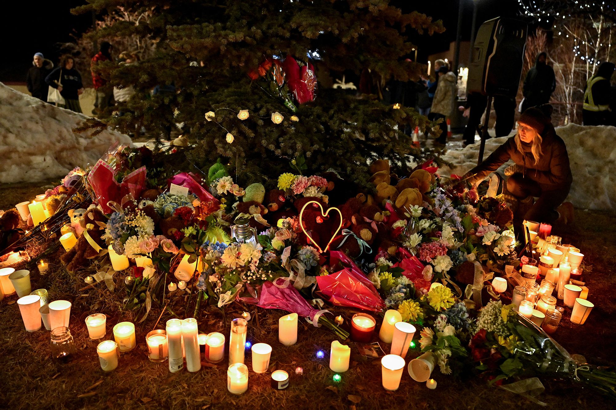 <i>Jennifer Gauthier/Reuters via CNN Newsource</i><br/>A woman pays tribute during a vigil