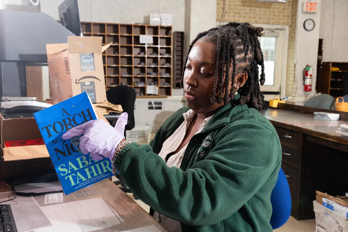 Alexis Page, an administrative assistant, scans mailed-in books for possible contraband at the Texas Department of Criminal Justice's Wynne Unit in Huntsville on May 21, 2026.