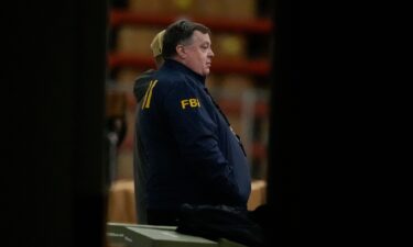 An FBI employee stands inside the Fulton County Election Hub as the FBI takes Fulton County 2020 Election ballots